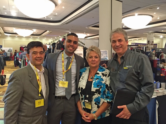 Mike Schenker, MAS, (right) introduces Michele Jennrich, MAS, to (from left) Rob Pettet, district director for Rep. Scott Garrett, and Dinesh Suryawanshi, a projects specialist for Sen. Cory Booker, on the SAAGNY Fall Showcase show floor.