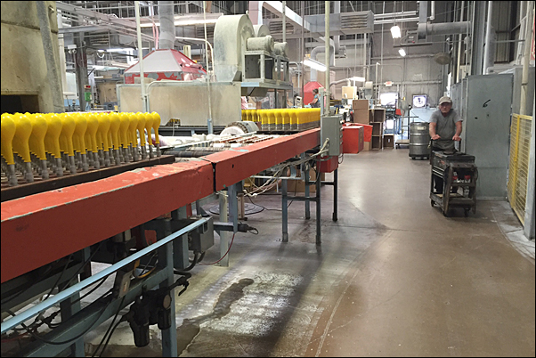Freshly dipped balloons ride the assembly line before being dried and going through quality control checks.