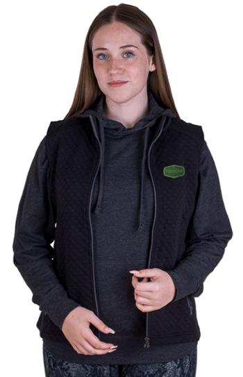 woman wearing black quilted full-zip vest with logo by Vantage